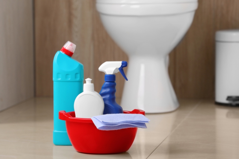 toilet cleaning materials on bathroom floor