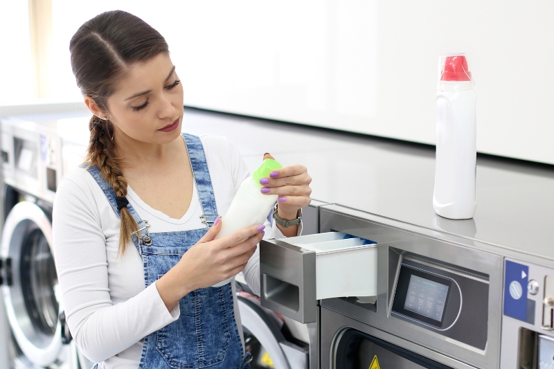 woman checking fabric softener bottle