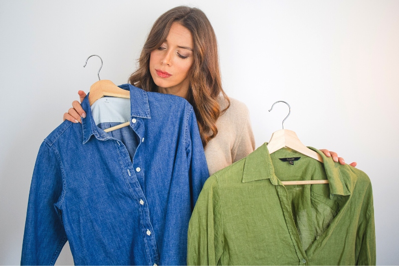woman choosing which blouse to wear