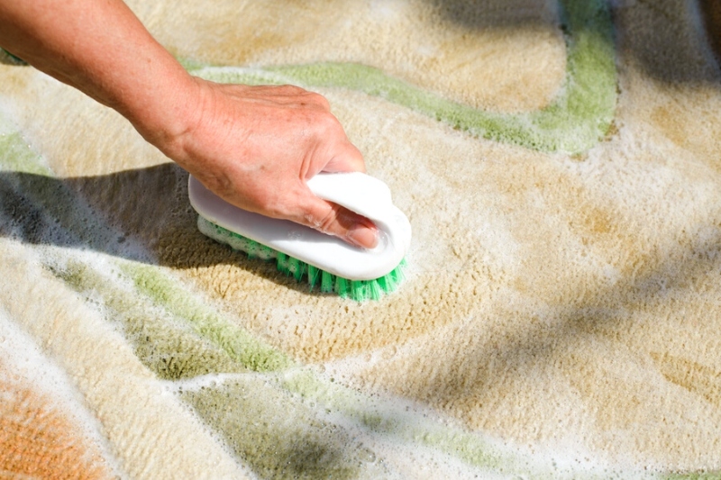 brushing dirty rug