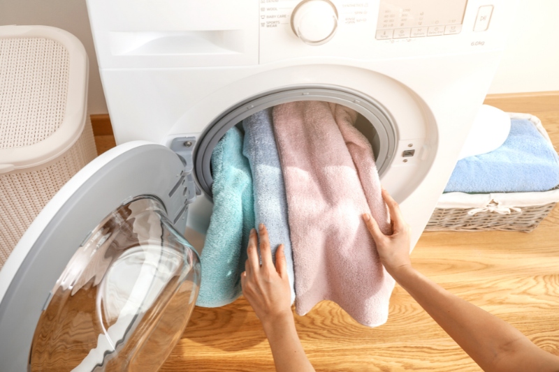 putting towels in the washing machine