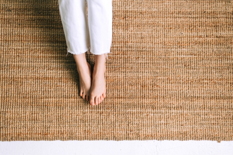 woman feet on jute rug