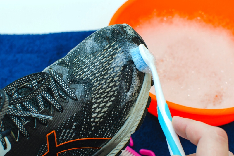 clean shoes with toothbrush