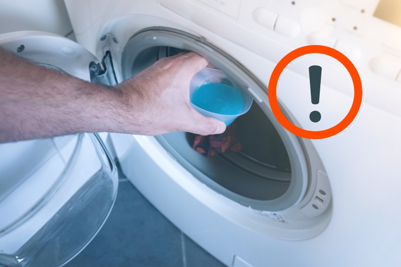 putting fabric softener in washer drum