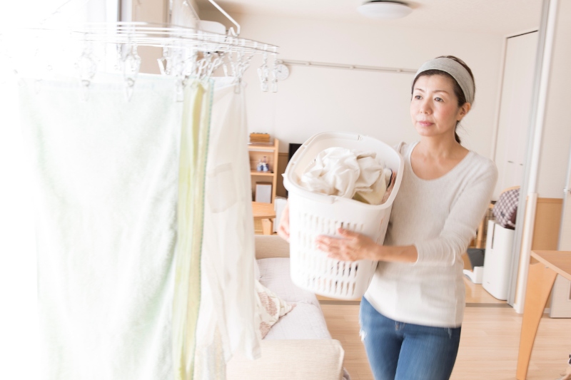 woman drying laundry indoors