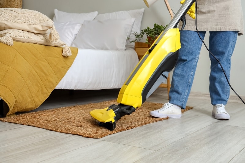 Vacuuming bedroom floor