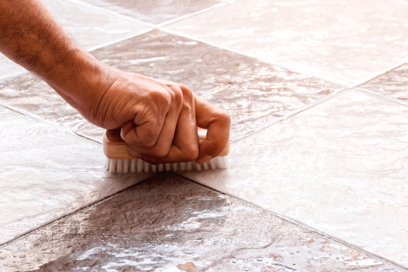 cleaning tiles by scrubbing