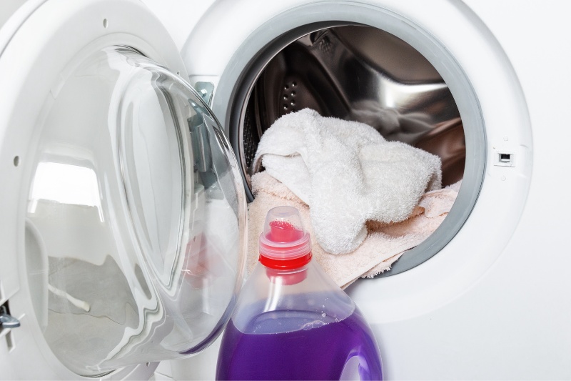 laundry detergent and clothes in washing machine