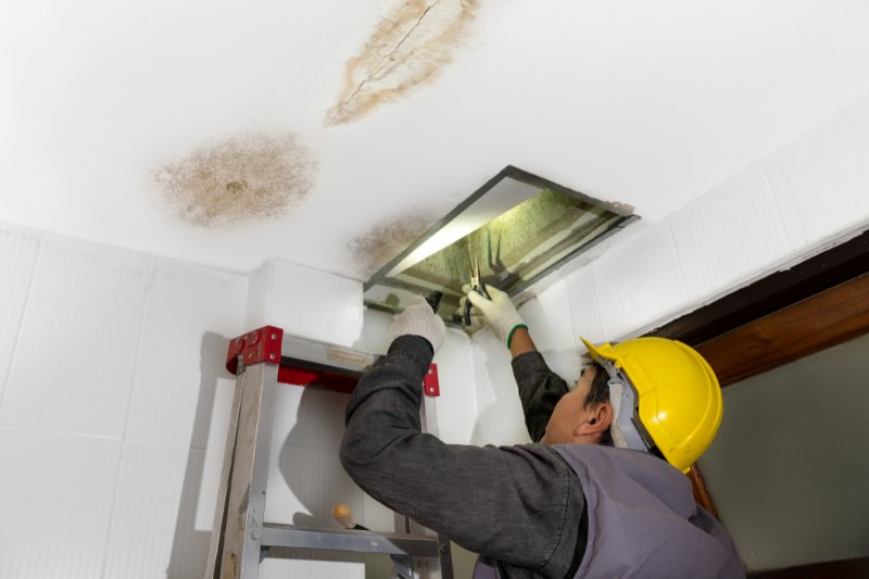 man repairing ceiling