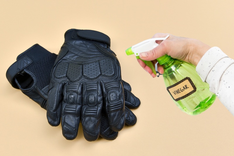spray leather gloves with vinegar and water