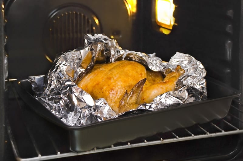 Chicken in foil in oven tray