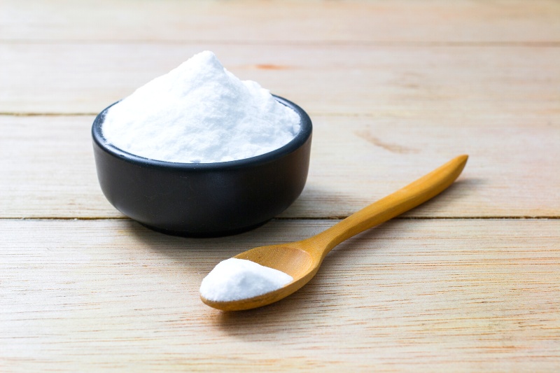 bowl and spoon of baking soda on table