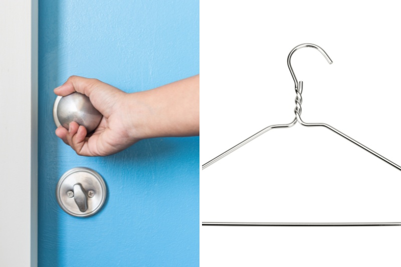 hand holding doorknob and metal coathanger