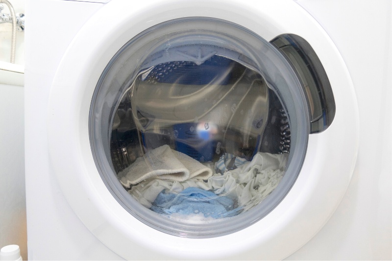 washing machine drum with clothes inside