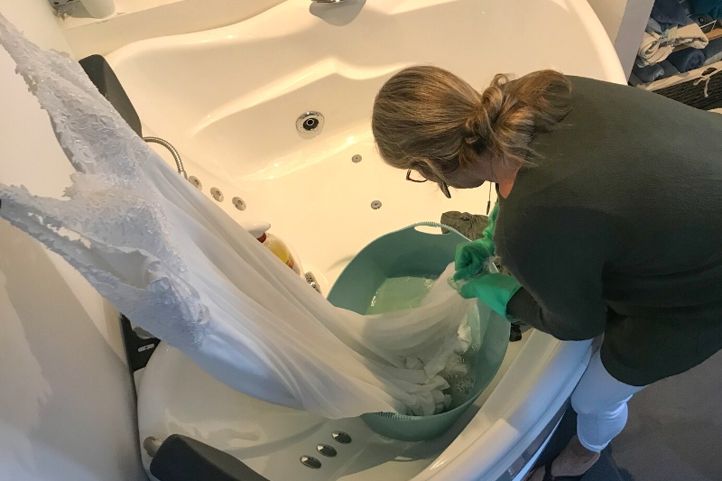 woman hand washing wedding dress