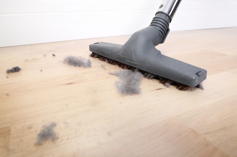 Vacuuming dust off floor