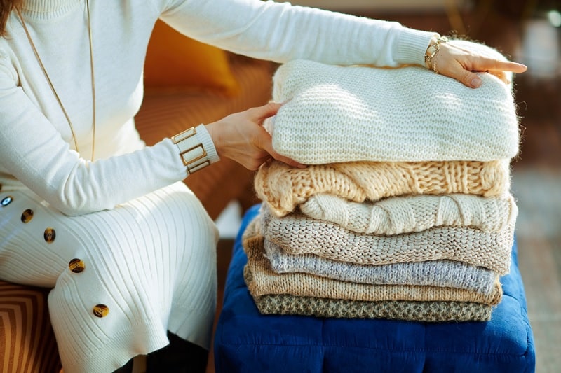 Woman folding sweaters