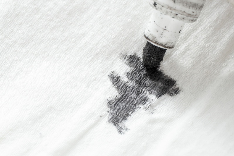 black ink marker stain on white fabric
