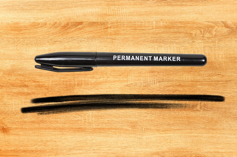 black permanent marker on wooden table