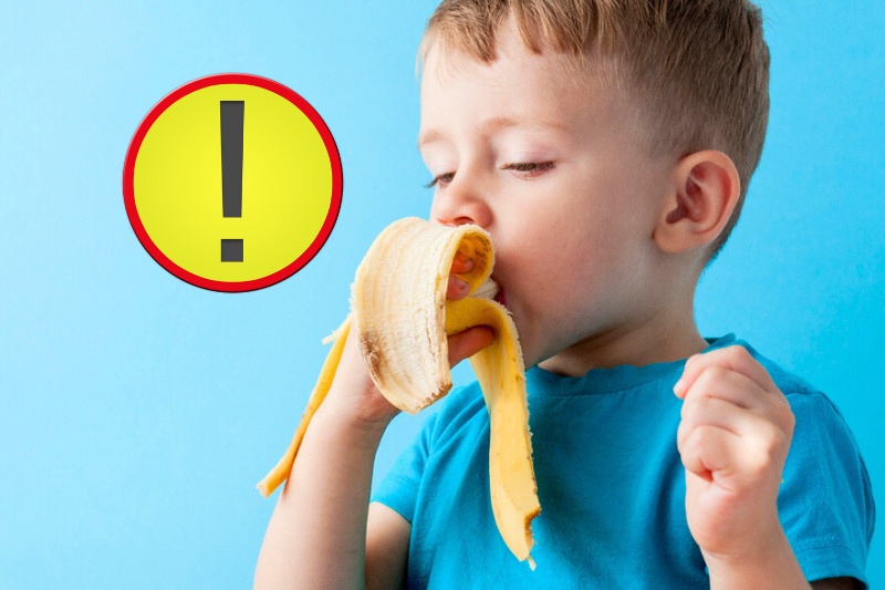 child eating banana