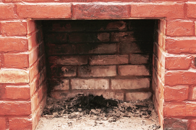 dirty black soot on brick fireplace