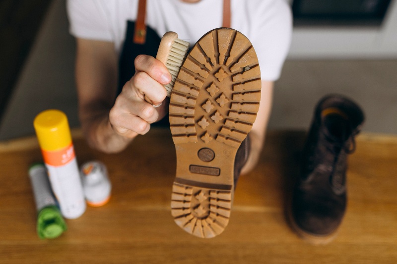 man cleaning shoes