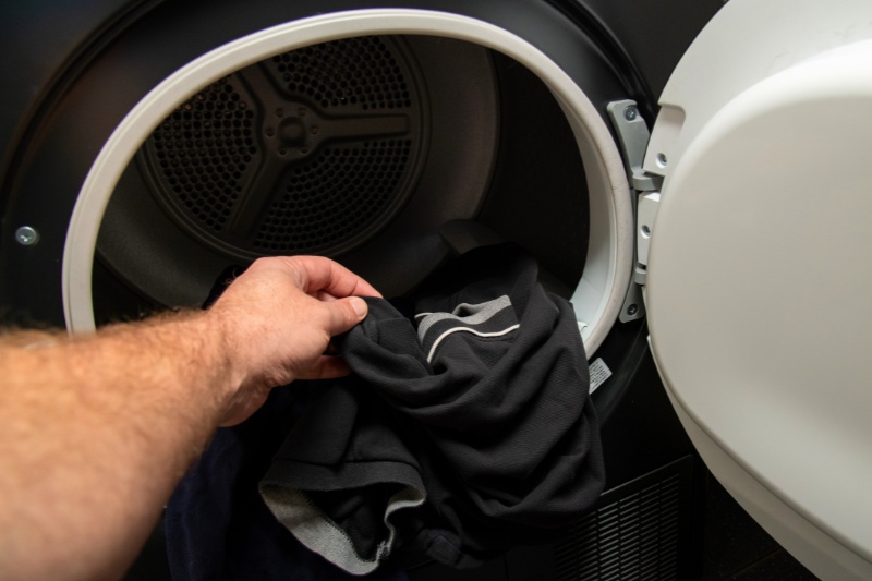 putting clothes inside tumble dryer