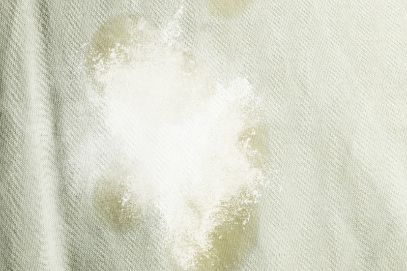 white powder sprinkled on grease or oil stain
