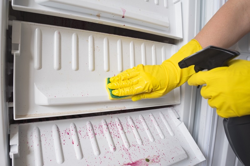 Cleaning freezer with spray