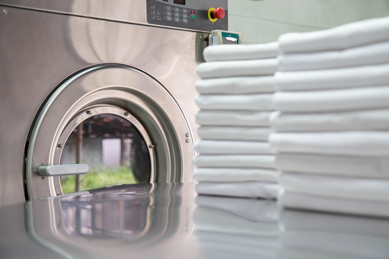 White towels and industrial washing machine