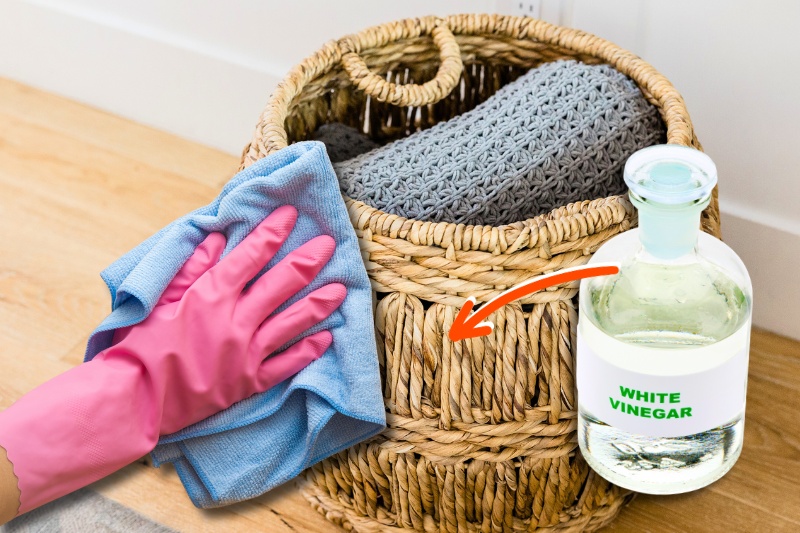 clean wicker basket with vinegar and cloth