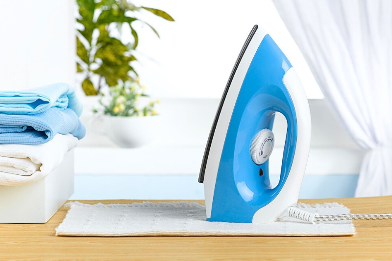 iron, towel and laundry on table