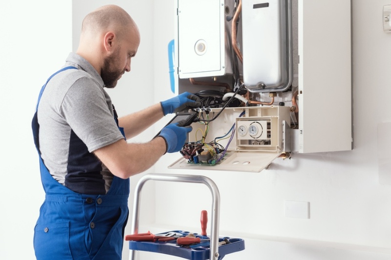 technician repairing heating system