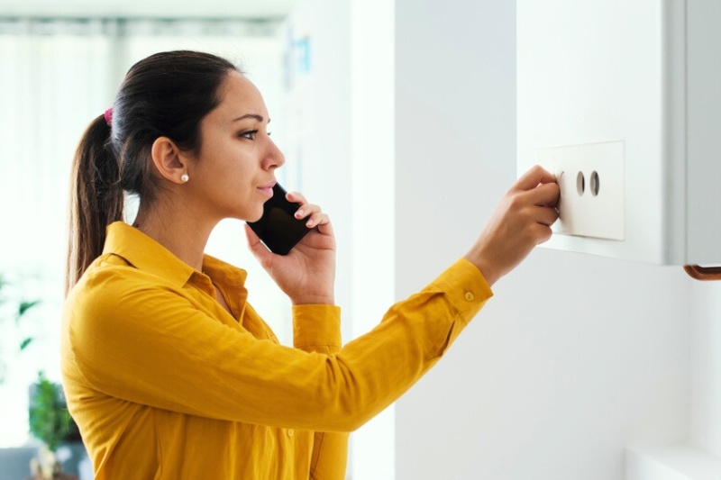 woman checking home heating system