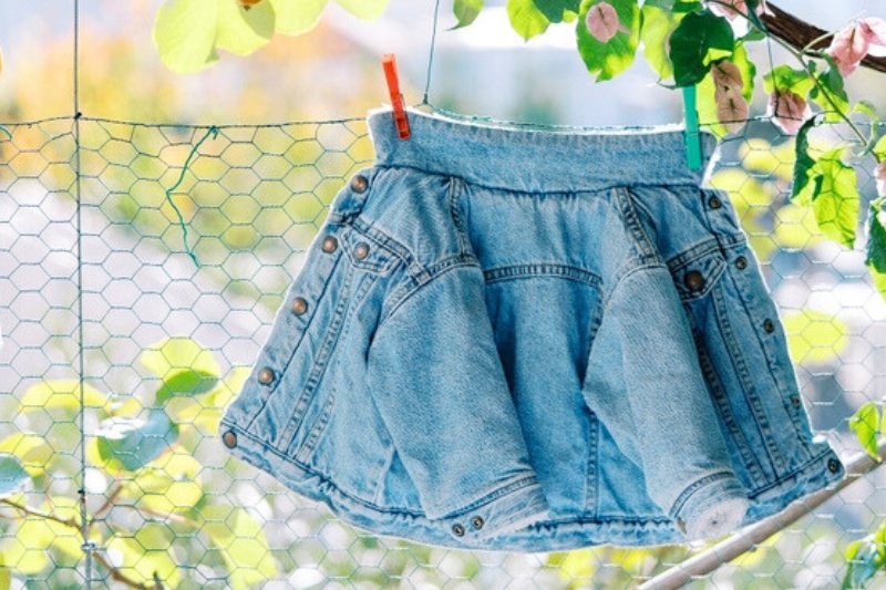 small denim jacket hanging outside to dry