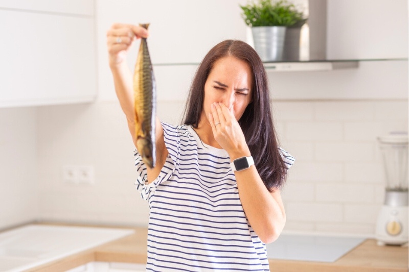 woman holding smelly fish