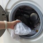 Putting clothes in washing machine