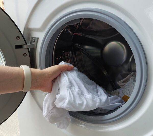 Putting clothes in washing machine