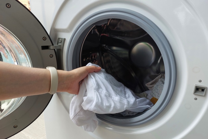 Putting clothes in washing machine