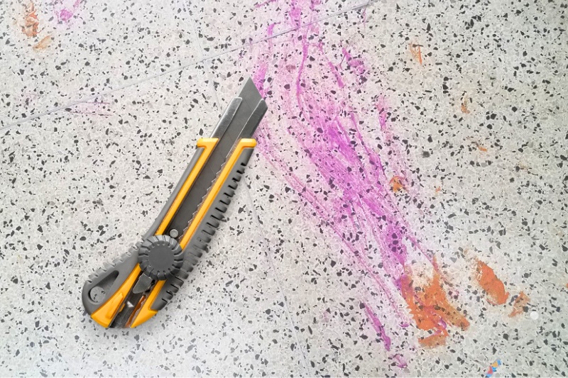 Scrape off paint on tile with a knife