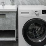 Washing machine by sink