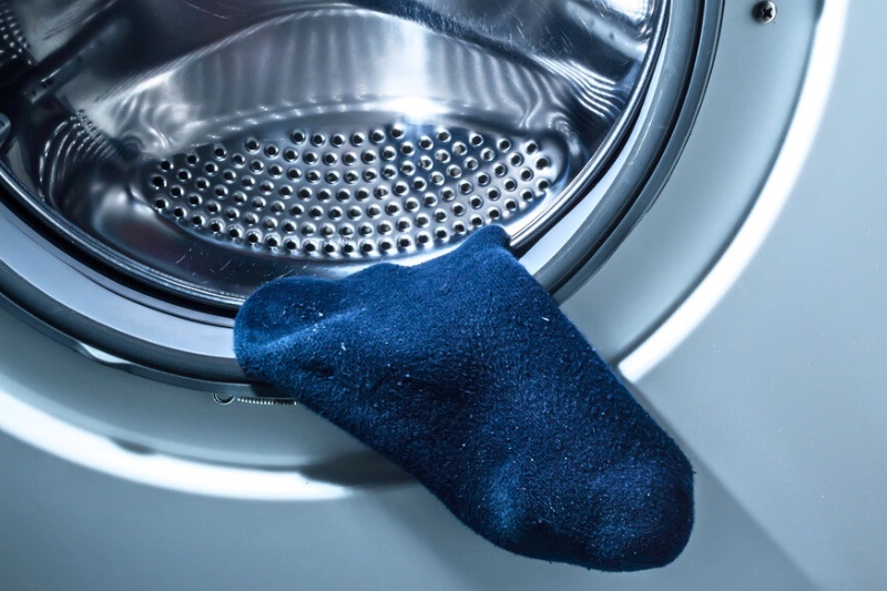 blue sock stuck in washng machine seal