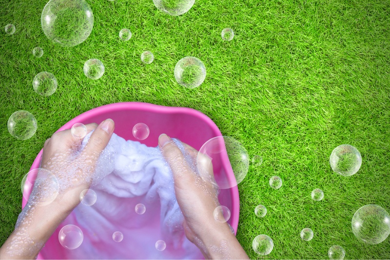 handwashing laundry on grass