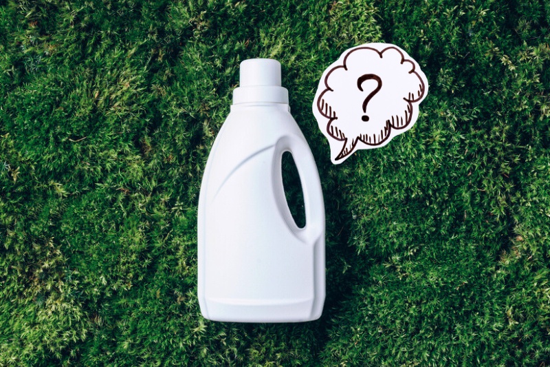 liquid laundry detergent on grass