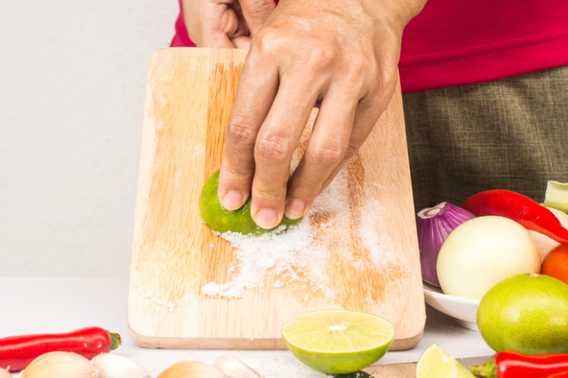 rubbing chopping board with lemon and salt