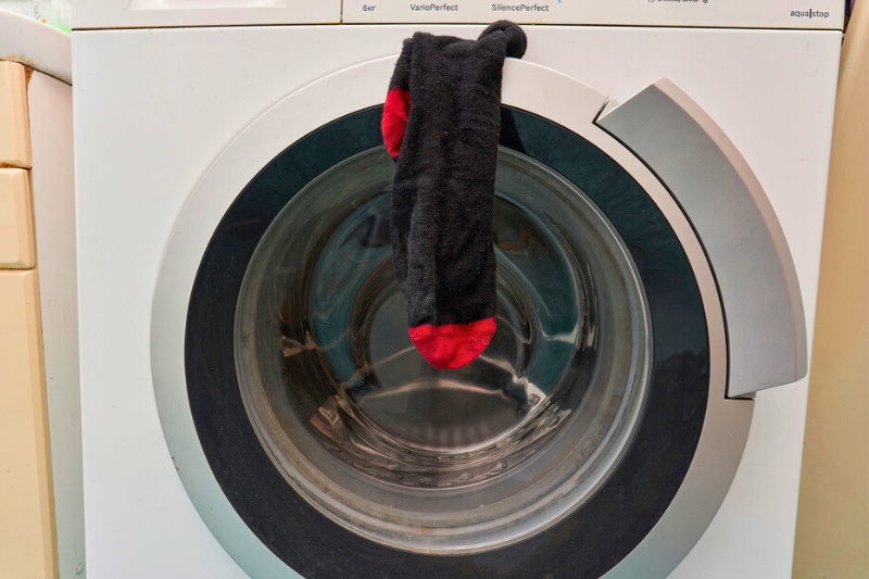 black red sock stuck in washing machine door