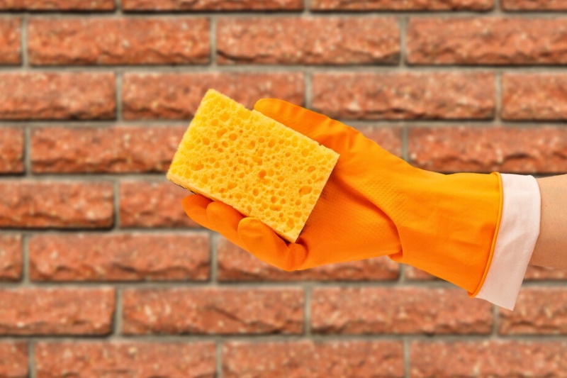 cleaning gloves and sponge for cleaning brick wall