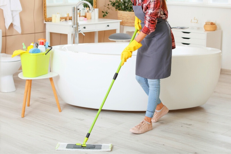 woman mopping bathroom floor